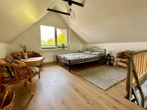 a attic room with two beds and a window at Apartament Loftowy- Bory Tucholskie in Świekatowo