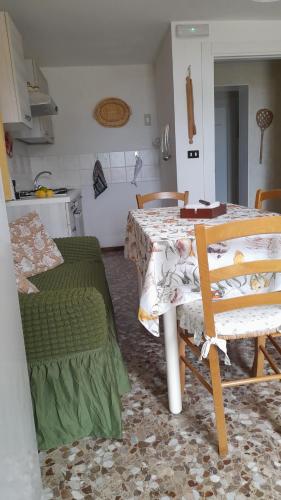 a kitchen with a table and chairs in a room at Casa dei sospiri in Polignano a Mare