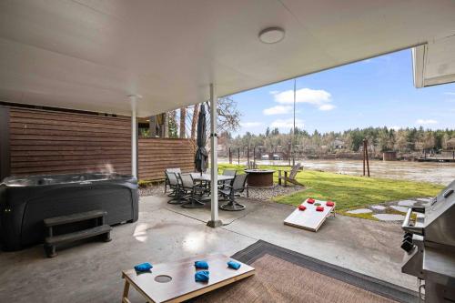 a living room with a pool table and a large window at River Forest Retreat in Milwaukie