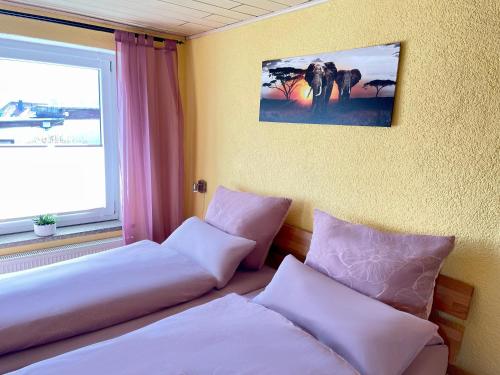 a hotel room with two beds and a window at Ferienwohnung Beyer Friedrichroda in Friedrichroda