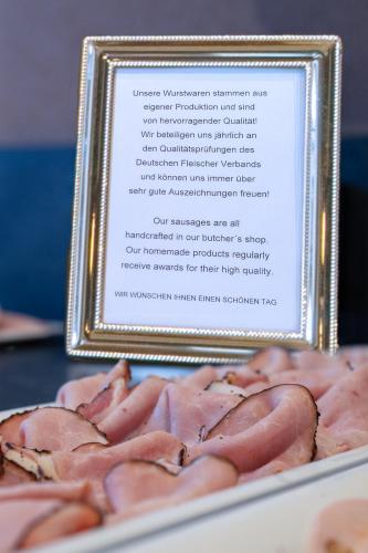 a framed picture of hot dogs on a plate at Hotel zur Post in Rohrdorf