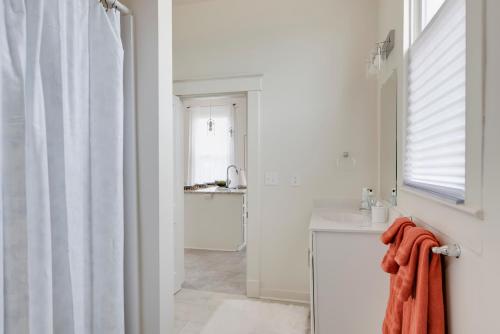 a bathroom with a sink and a shower curtain at 5 BR home in Downtown Colonial Beach in Colonial Beach