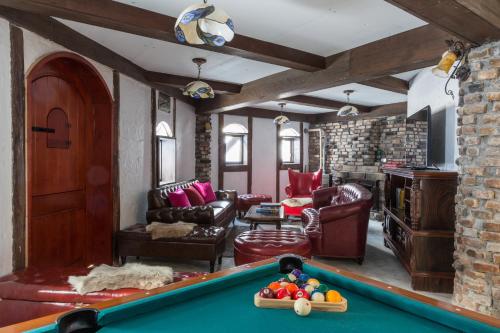 a living room with a pool table in it at Chalet Hakuba in Hakuba