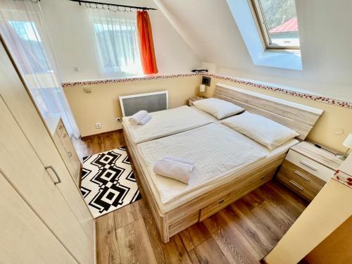 a small room with a bed and a window at Privát Adriana in Kremnica