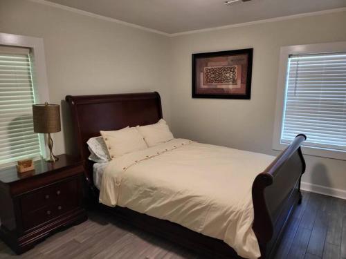 a bedroom with a large bed and two windows at 5. Cozy cabin in Guntersville in Guntersville
