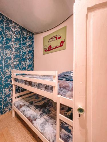 a bedroom with two bunk beds with a car picture on the wall at Cool Canaria in Agaete
