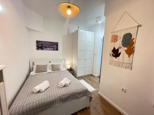 a bedroom with a bed with two pillows on it at Apartment 42 - City Center in Belgrade