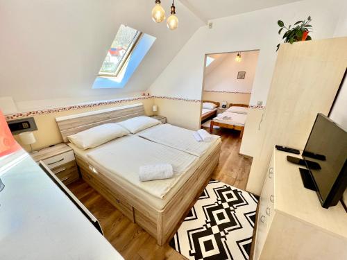 a small bedroom with a bed and a desk at Privát Adriana in Kremnica