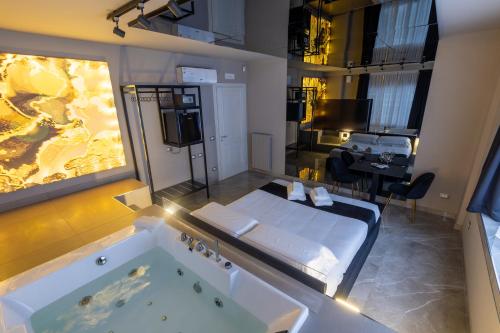a bathroom with a tub and a room with a table at Maximum Exclusive Suite & Spa in Palermo