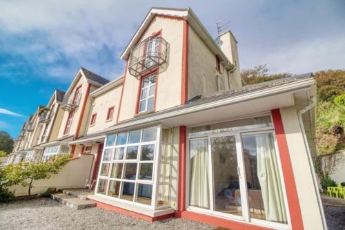 an exterior view of a house with large windows at Ashton Beach House in Tramore