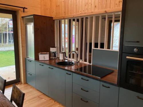 a kitchen with a sink and a counter top at gemütliches Holzhaus am See in Warin