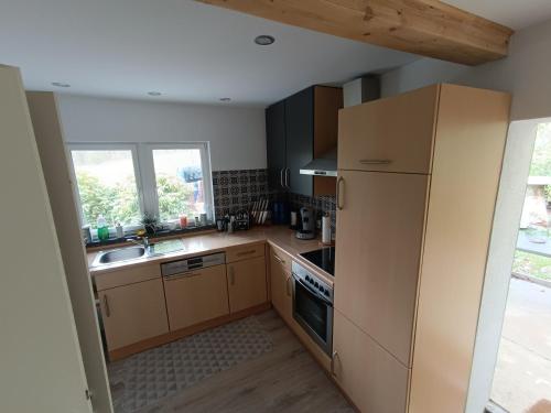 a kitchen with a refrigerator and a sink at Ferienhaus Wald&Wiese 