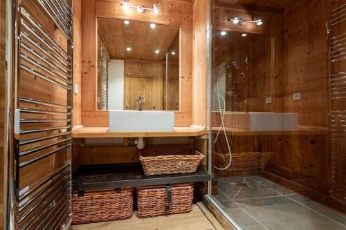 y baño con lavabo y espejo. en L'ourse et L'ange - Luxury chalet (8p). 3 bedrooms, 2 bathrooms and a loft. In the centre of Vallandry, with ski-in & out, en Landry