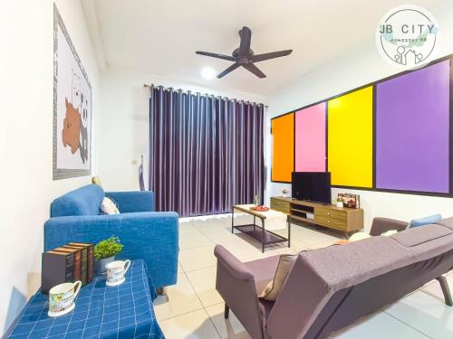 a living room with a blue couch and a tv at Pangsapuri Meridian by RR JBcity in Nusajaya