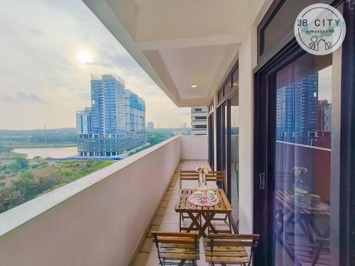 a balcony with a table and chairs and a view of a city at Pangsapuri Meridian by RR JBcity in Nusajaya