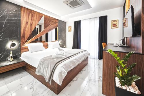 a bedroom with a bed and a desk in a room at MiM Apartments in Skopje