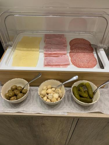 a refrigerator filled with different types of meat and vegetables at B&B D'Amari Affittacamere in Palermo