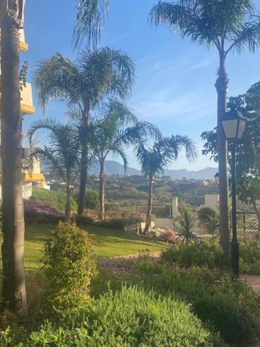 a view of a park with palm trees and a street light at Mijas,Calanova grand Golf in La Cala de Mijas