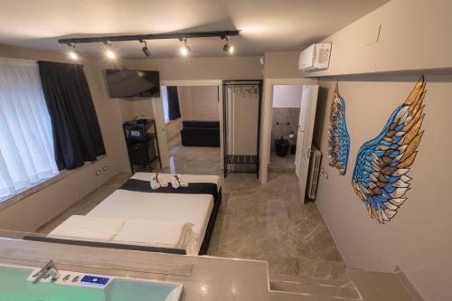 a room with a bed and wings on the wall at Maximum Exclusive Suite & Spa in Palermo