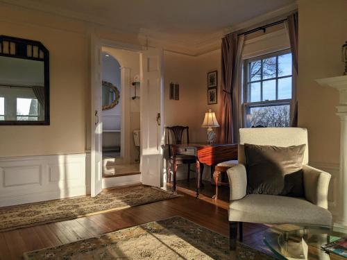 a living room with a chair and a desk at Stanton House Inn in Greenwich