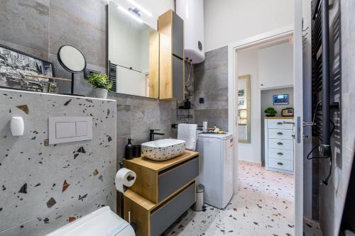 a bathroom with a sink and a toilet in a room at Sylvia suite@Kantrida in Rijeka