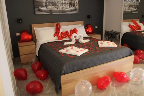 a bedroom with a bed with red balloons on the floor at B&B D'Amari Affittacamere in Palermo