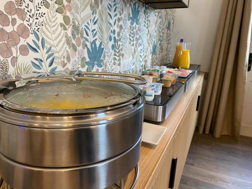 a large metal pot on a counter in a room at Sure Hotel by Best Western Sarlat-la-Canéda in Sarlat-la-Canéda