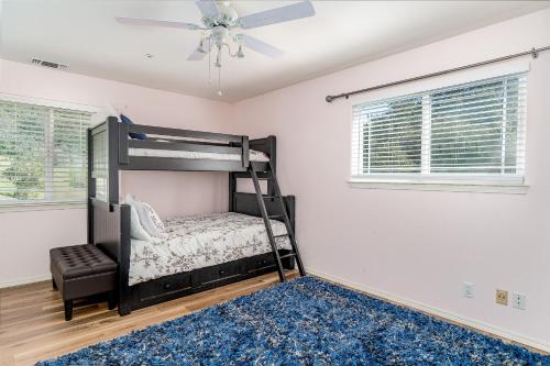 a bedroom with a bunk bed and a ceiling fan at Hilltop Heaven in Atascadero