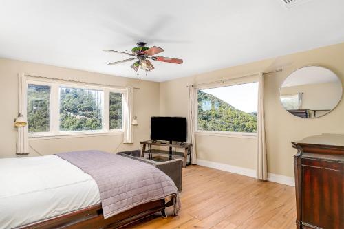 a bedroom with a bed and a flat screen tv at Hilltop Heaven in Atascadero