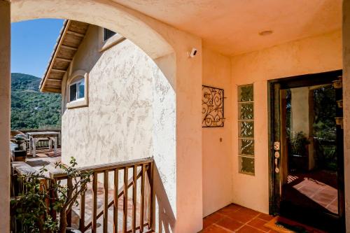 an entrance to a house with a door and a balcony at Hilltop Heaven in Atascadero