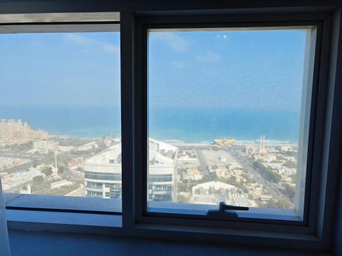 a window with a view of a city at Diamond Room in Shared Apartment in Ajman 