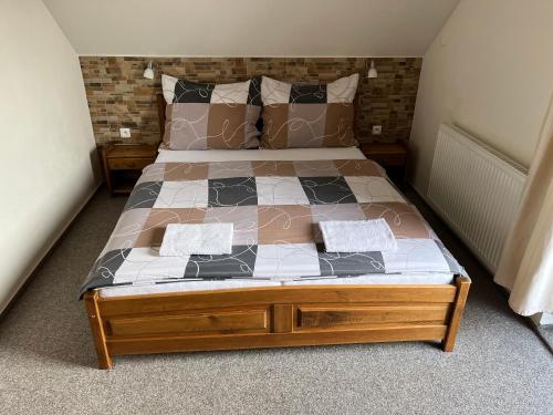 a bedroom with a bed with a wooden frame at Na Planýrce in Paseky nad Jizerou