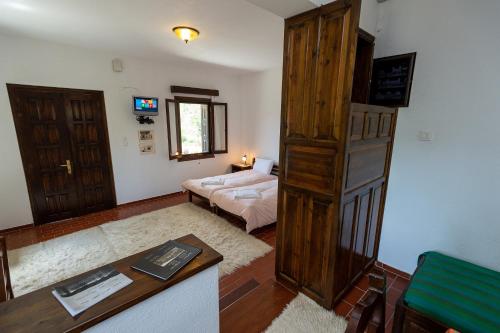 a living room with a bed and a table at Zmas Studios in Chorto