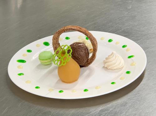 a white plate with a chocolate dessert on it at Hotel Restaurant Emshorn in Oberems