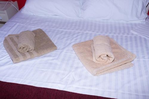 two towels sitting on top of a bed at Estia's Casetta in Ágios Prokópios