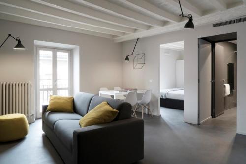 a living room with a couch and a bedroom at Brera Apartments in Garibaldi in Milan