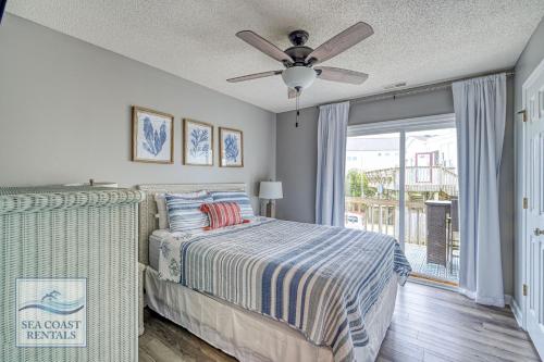 a bedroom with a bed and a ceiling fan at The Salted Rim in North Topsail Beach