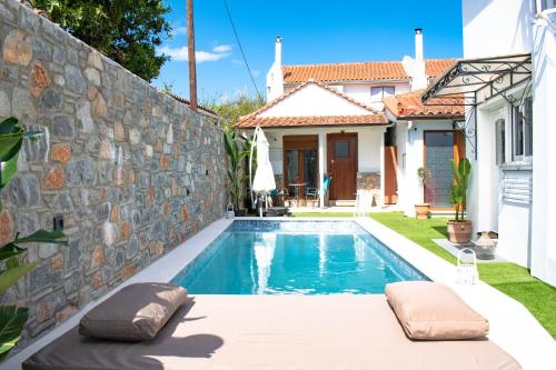 a swimming pool in the backyard of a house at Del Sol Suites in Skiathos