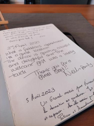 a piece of paper with handwriting on it on a table at Groom Épernay - Le Petit Tonnelier in Épernay