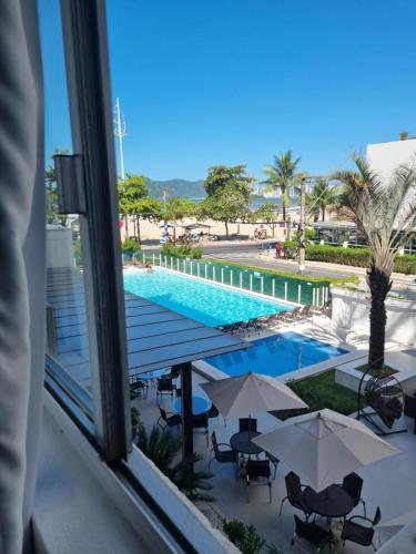 a view of a swimming pool from a hotel window at Marambaia Hotel e Convenções in Balneário Camboriú