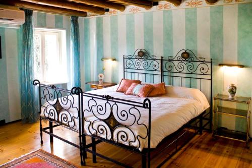 a bedroom with a bed with two pillows on it at Villa Avesa in Verona