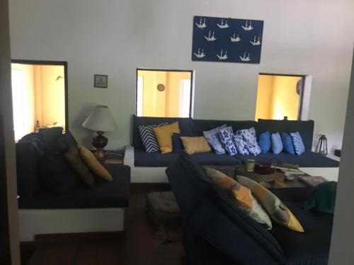 a living room with a blue couch with pillows at Pousada Casa da Montanha in Angra dos Reis