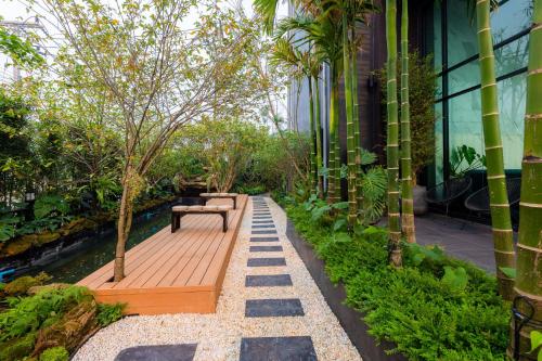a garden with a bench on a wooden deck at The View Chiang Dao in Chiang Dao