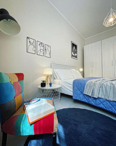 a bedroom with a bed and a couch and a chair at 50 Papiniano apartment in Milan