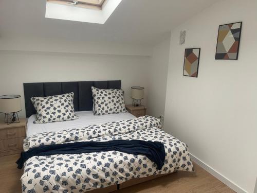 a bedroom with a bed and two pillows on it at MW 7B Apartament in Rzeszów