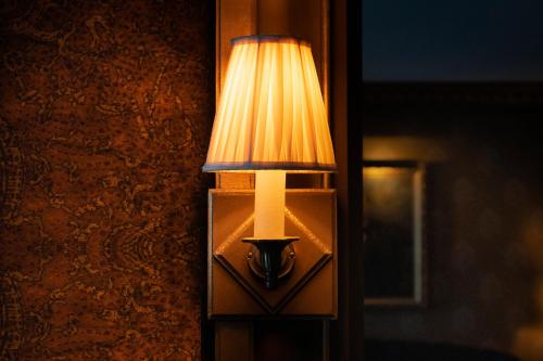 a lamp on the side of a wall at Maison Proust, Hotel & Spa La Mer in Paris
