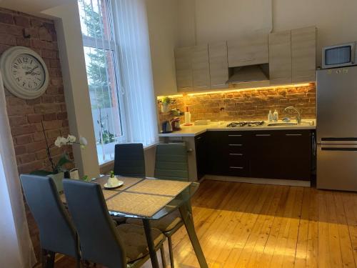 a kitchen with a table and chairs and a dining room at Kranto Luxe Stay in Panevėžys