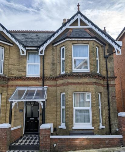 a brick house with a pitched roof at Spring Gardens, 4-bedroom seaside family home in Shanklin