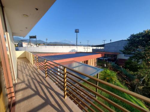 a balcony with a view of a baseball field at Beautiful view suite Suite vista hermosa in Macas