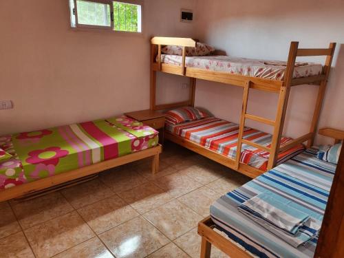 a room with two bunk beds and a couch at RESIDENCIAL LOS ANDES in Jardín América
